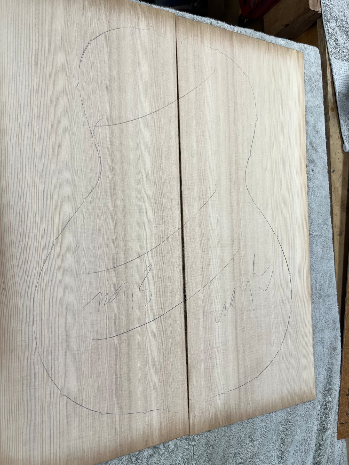 Sitka spruce top halves with the parlor guitar body shape drawn in pencil