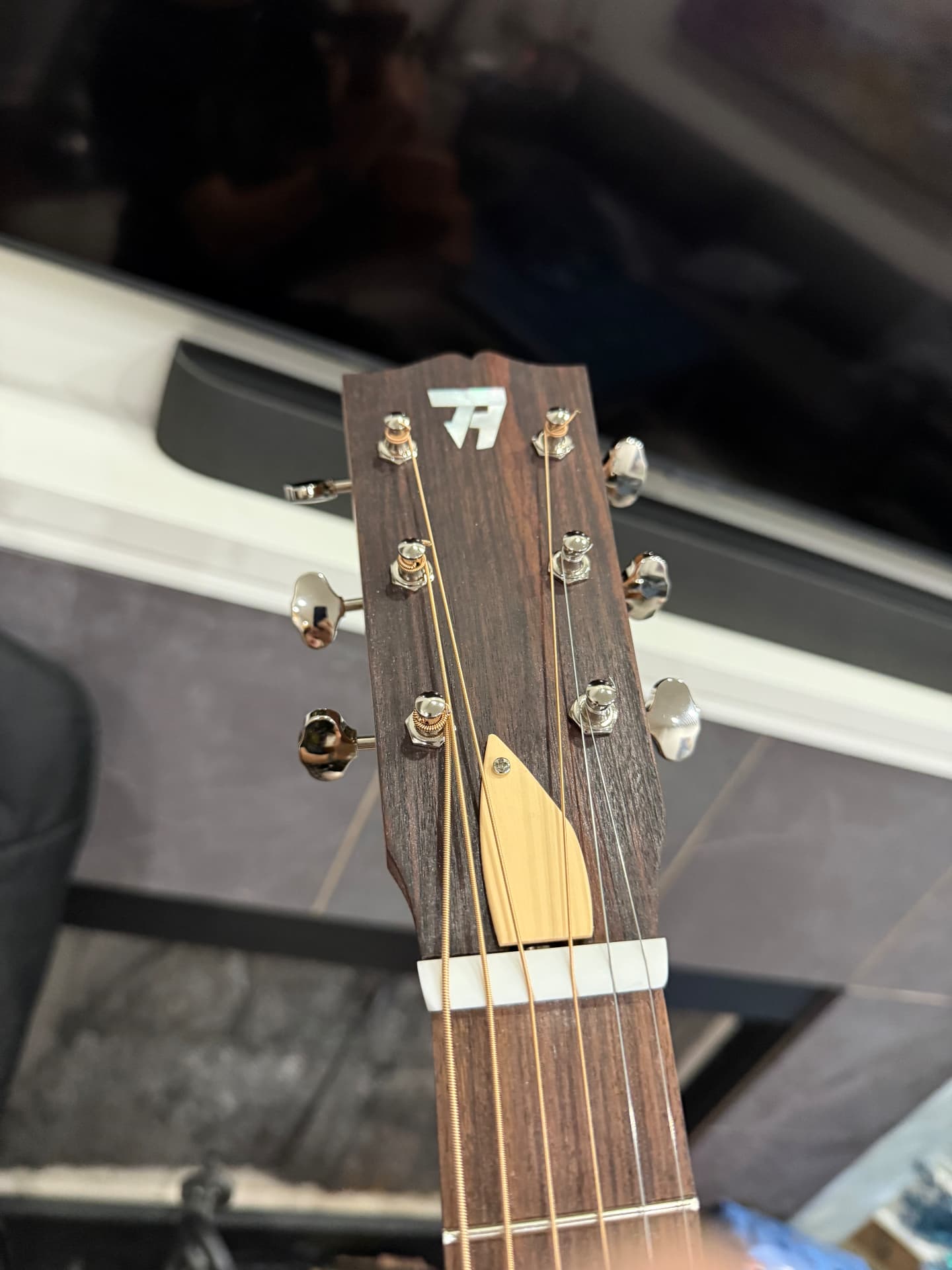 Finished headstock with tuners, nut, strings, and truss rod cover installed