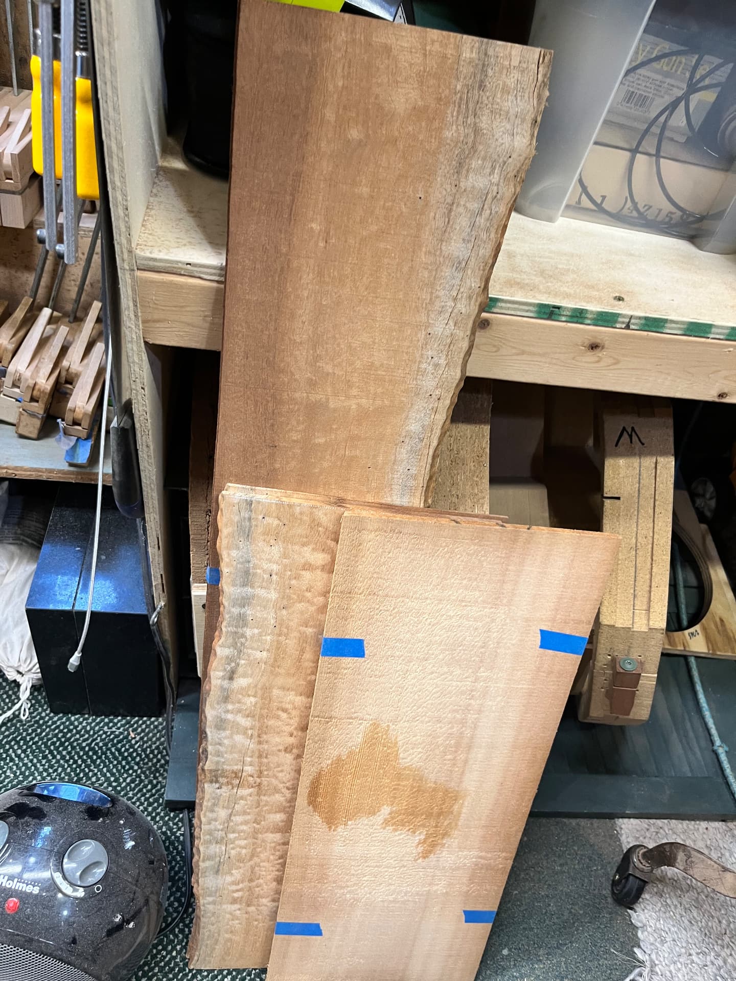 Rough guitar wood boards taped and stacked in the workshop