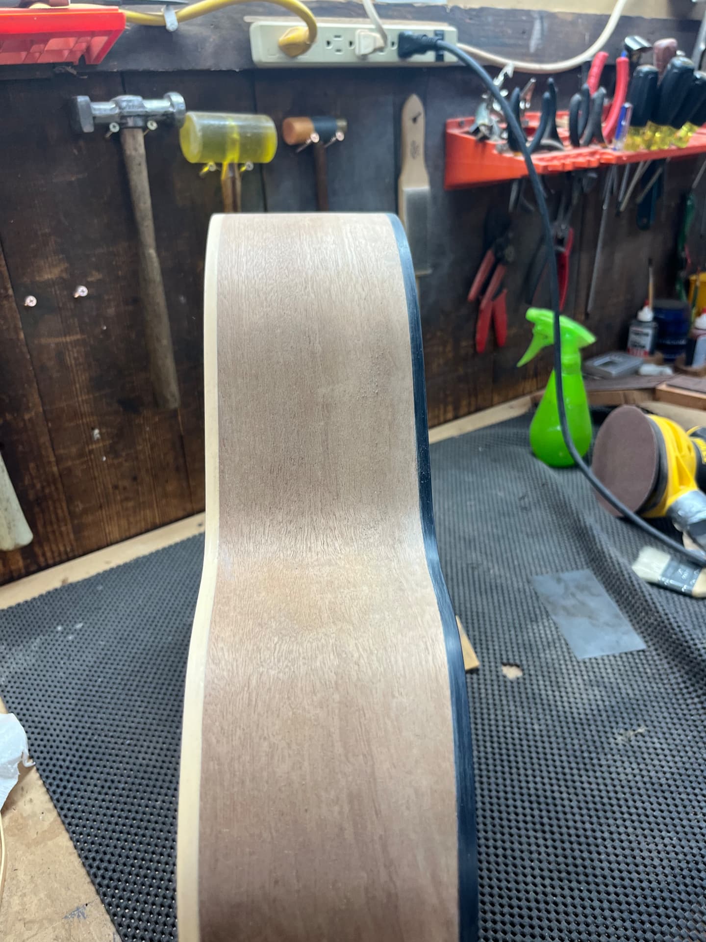 Sanded sapele side of the body with cream binding along the edge