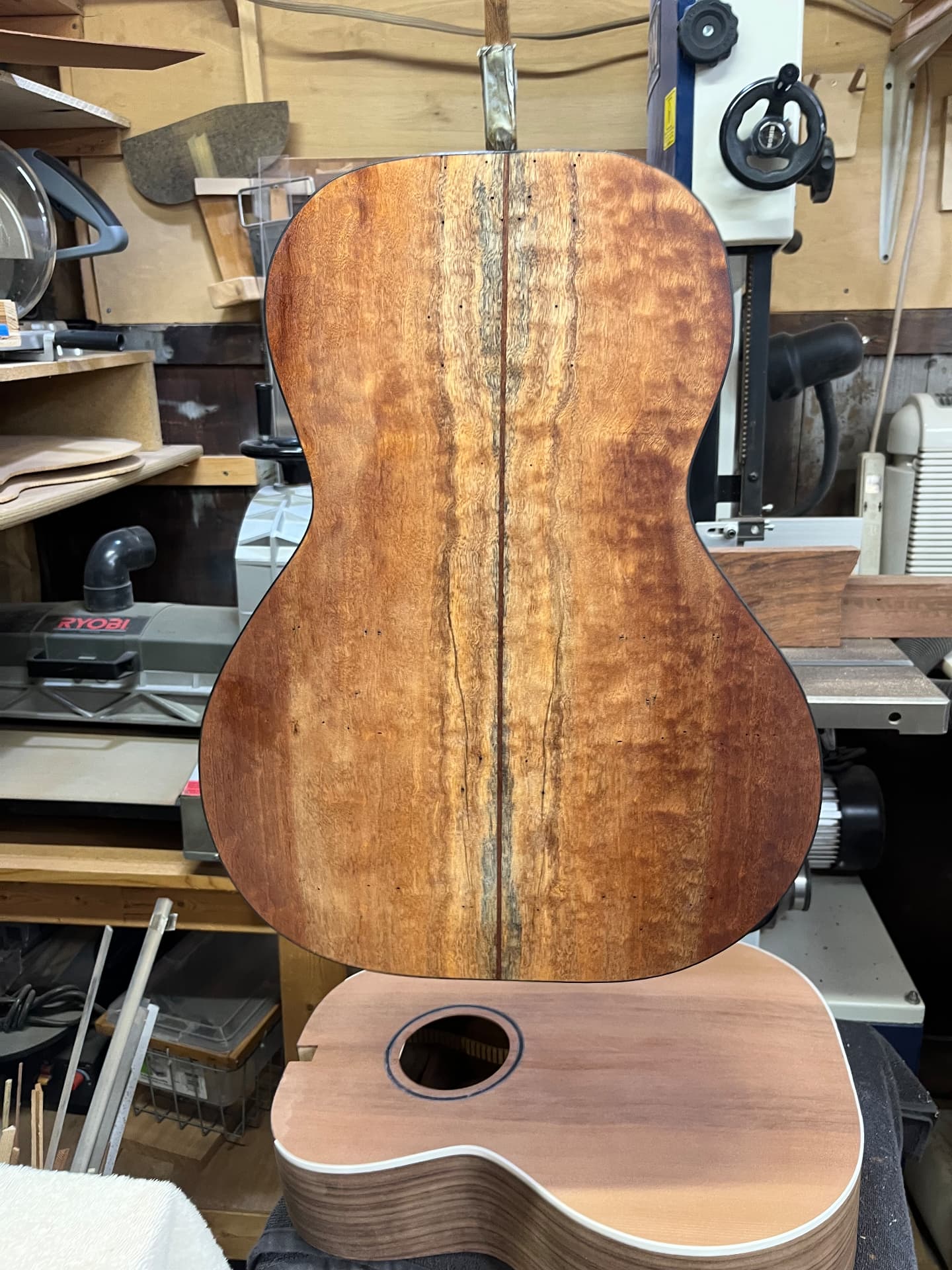 Varnished sapele back showing vibrant grain patterns in the workshop