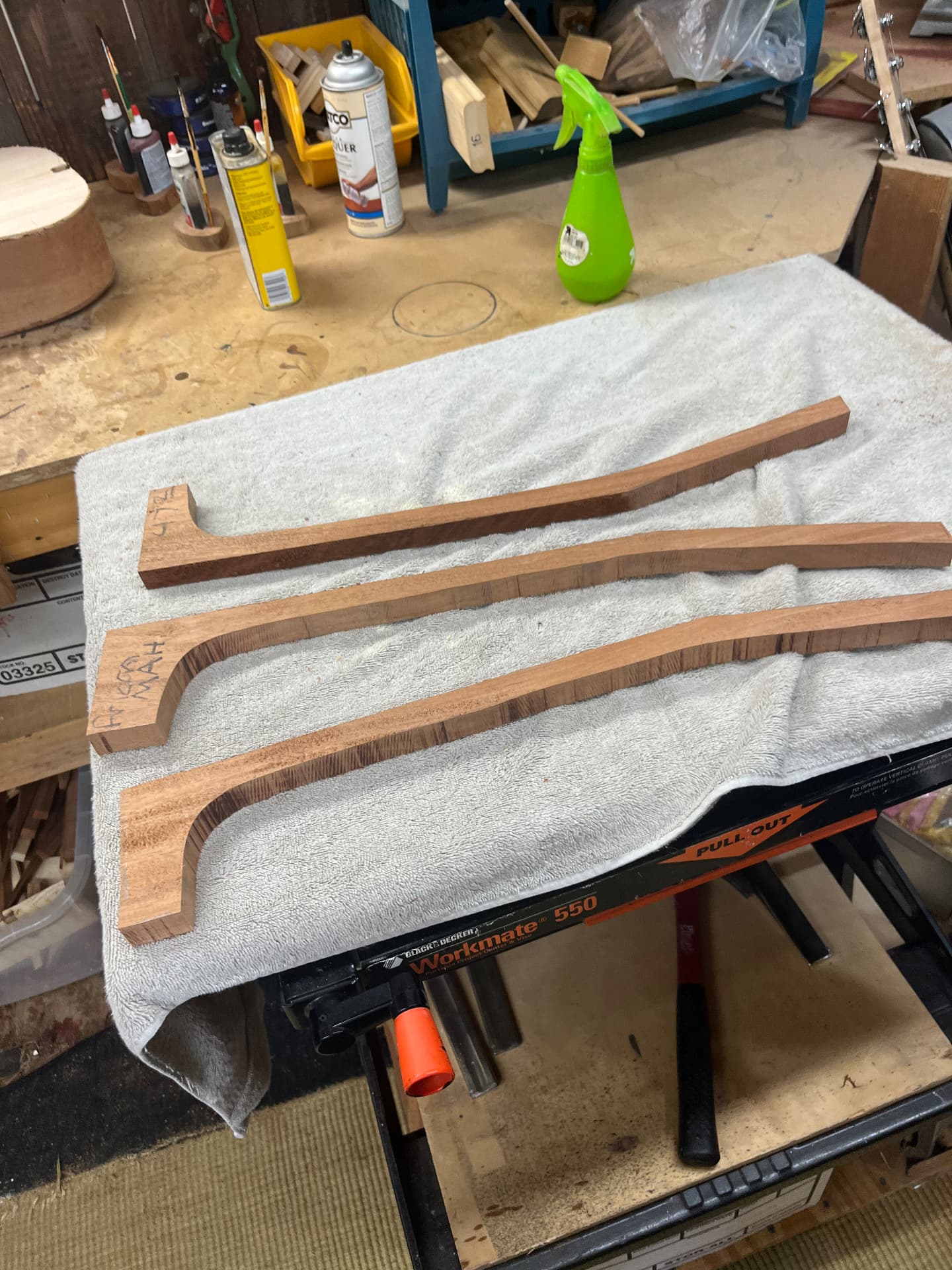 Three sapele neck sections cut to shape and laid out on a towel