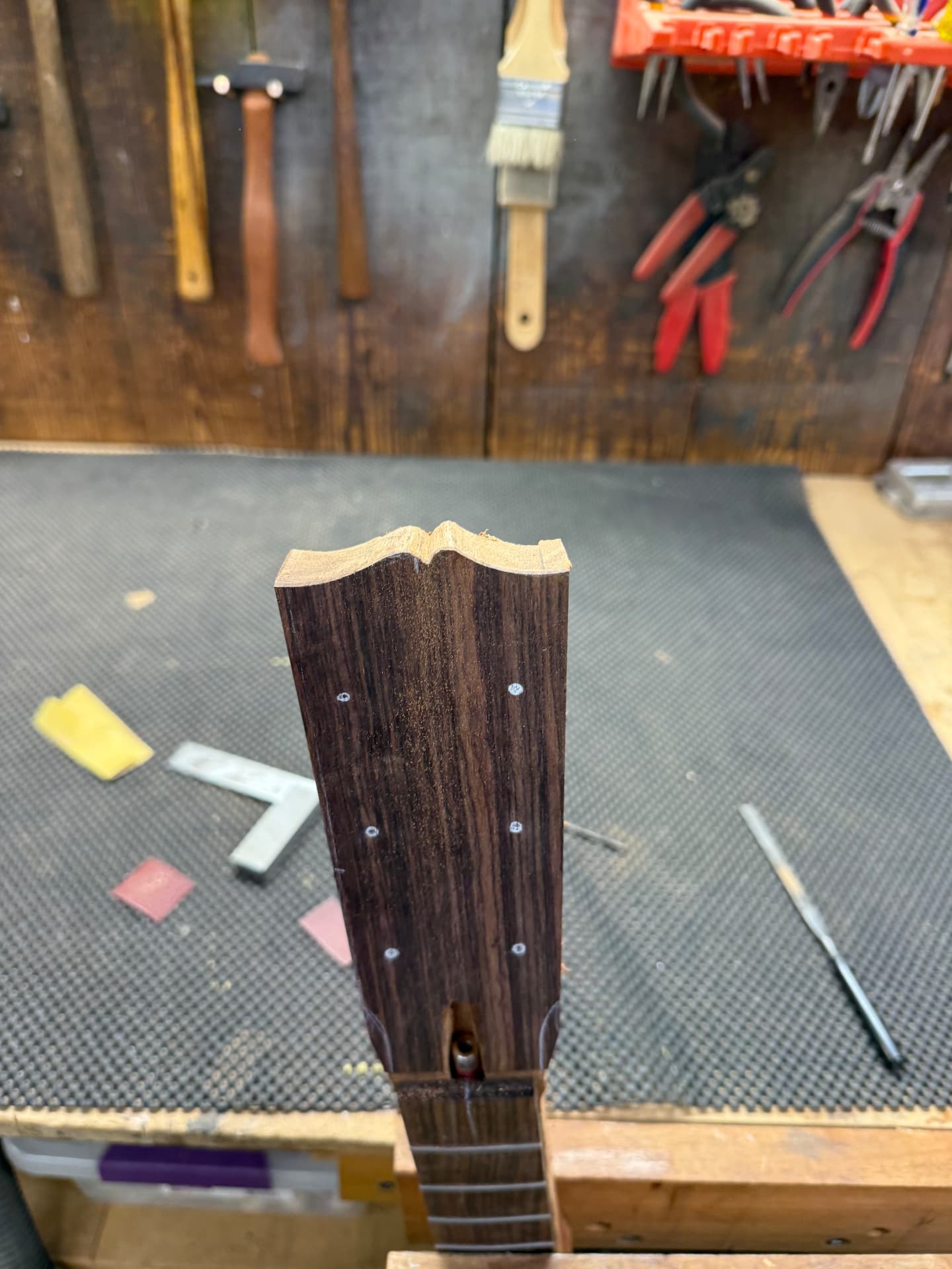 Rosewood headstock carved to shape on the workbench