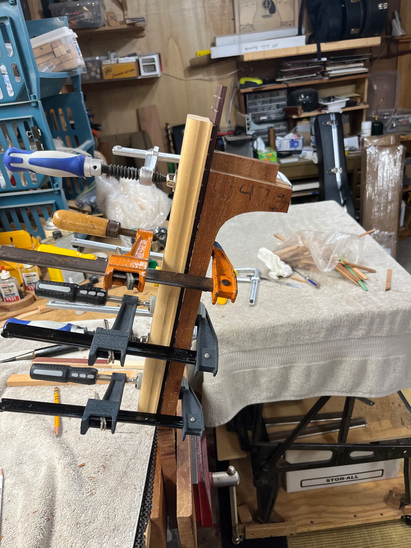 Fingerboard glued and clamped to the sapele neck on the workbench
